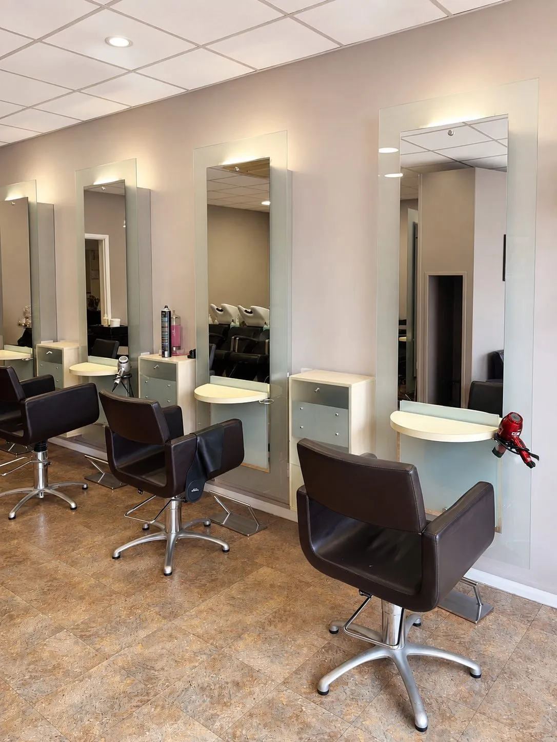A row of styling stations with tall mirrors