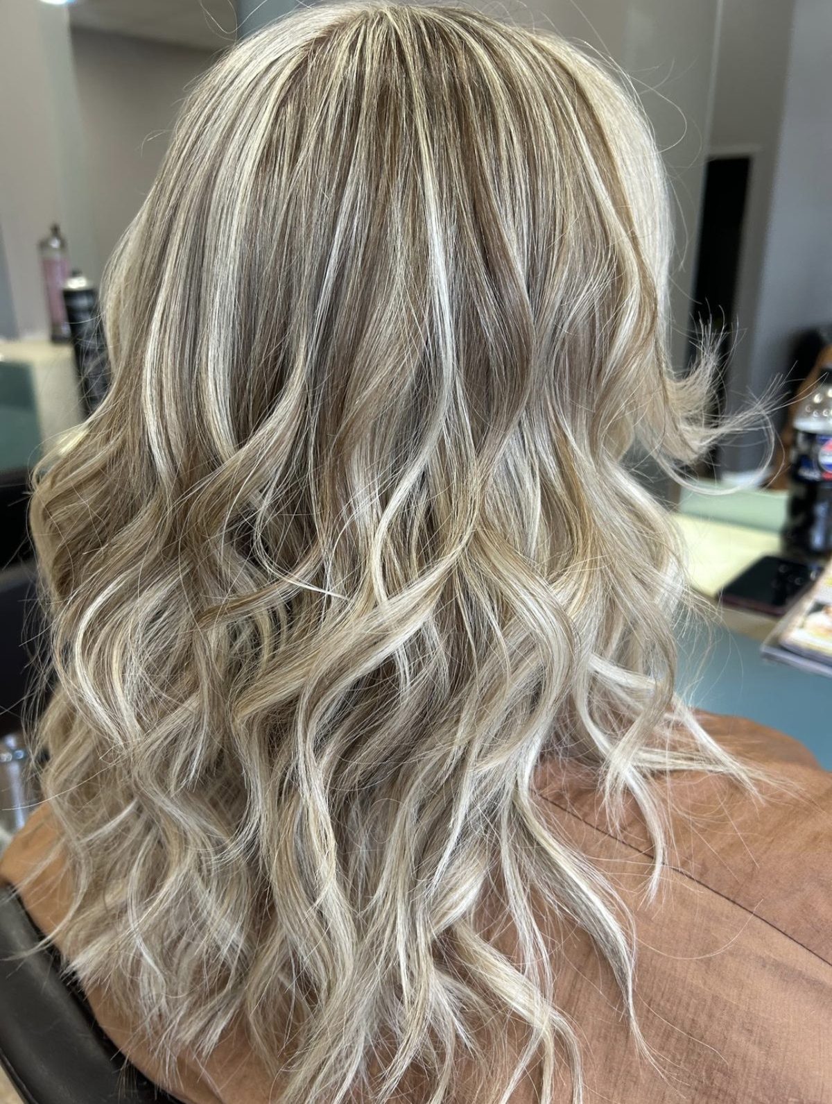 Long hair with cool blonde highlights, finished in soft beachy waves